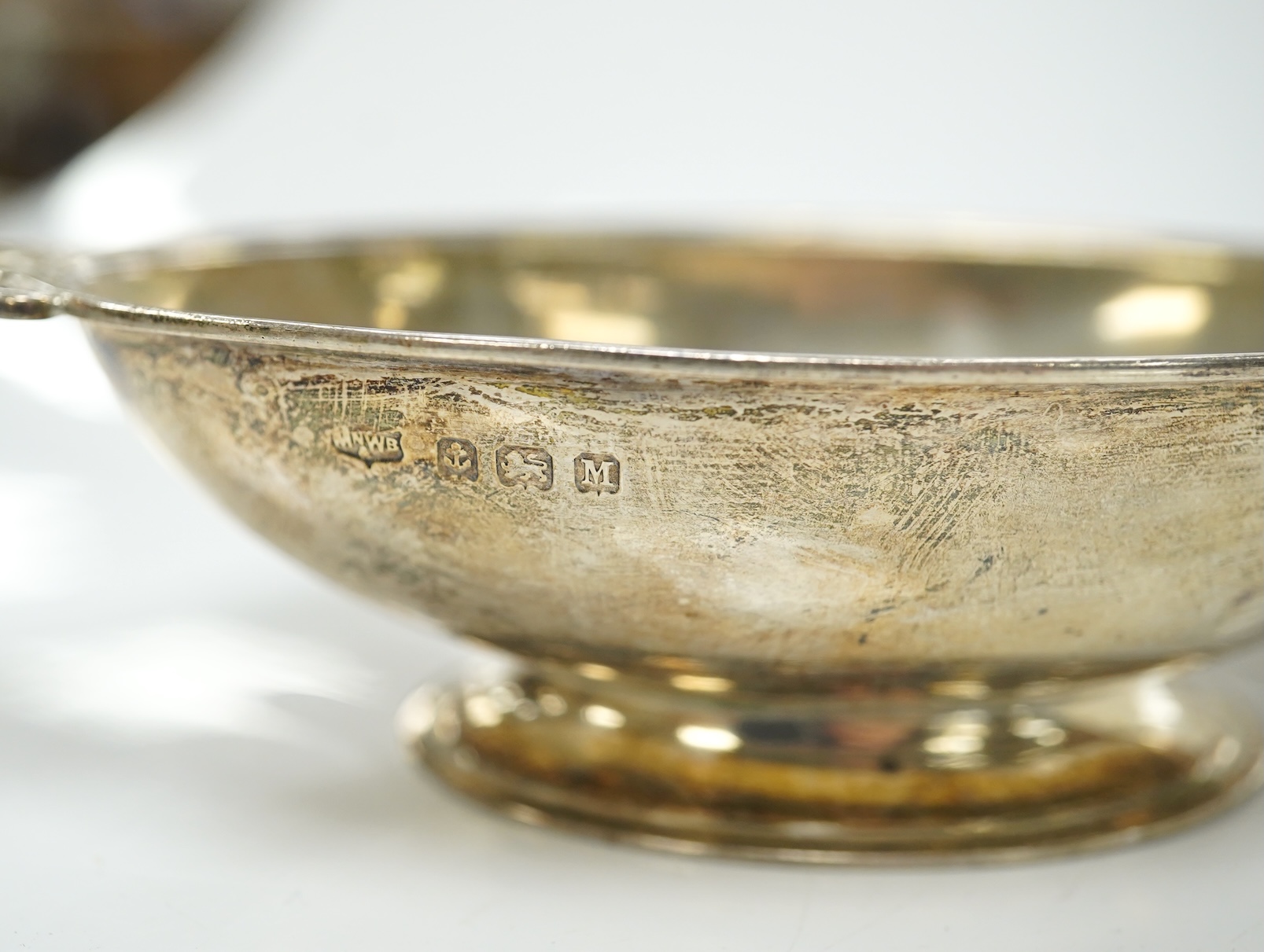 A pair of Edwardian pierced white metal dishes embossed with cherubs, a pair of two handled silver oval bowls, Birmingham, 1936 and two small baskets, one silver one 800 standard. Condition - poor to fair